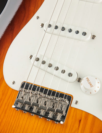 Close up picture of the bridge and pickups of a Fender Vintage Custom '55 Hardtail Strat Wide-Fade 2-Color Sunburst electric guitar.