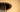 A closeup view of an acoustic guitar's abalone shell inlayed rosette.