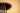 A closeup view of an acoustic guitar's abalone shell inlayed rosette.