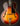 Vintage archtop guitar with a sunburst finish on a black background