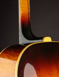 Close-up of a guitar's neck with a dark background