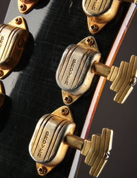 Close-up of Grover tuning machines on a guitar headstock