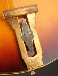 Close up of tailpiece on a vintage archtop guitar