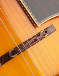 Close up of bridge on a vintage archtop guitar