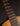 Close-up of a guitar's fretboard and strings on a dark background