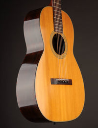 Side view of a Martin acoustic guitar on a black background
