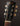 Gibson guitar headstock with tuning pegs on a dark background