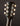 Close-up of a Gibson LG-2 headstock with tuning pegs on a dark background, back view