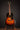 1947 Gibson LG-2 acoustic guitar with a sunburst finish on a stand against a dark background