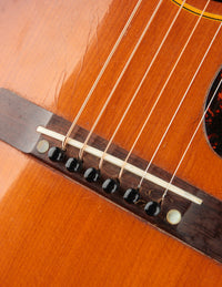Close up of bridge on a 1947 Gibson LG-2 acoustic guitar with a sunburst finish 