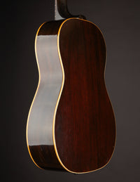 1947 Gibson LG-2 acoustic guitar with a sunburst finish on a dark background, back/side view 
