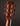 Close-up of a guitar headstock with tuning pegs on a dark background