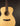 Acoustic guitar with a natural wood finish on a black background