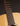 Close-up of a guitar's neck and headstock on a dark background