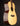 Acoustic guitar with a natural wood finish on a black background, side view