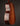 Acoustic guitar with a natural wood finish on a black background, side view