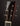 Close-up of a guitar headstock with tuning pegs on a dark background