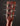 Close-up of a guitar headstock with tuning pegs on a dark background