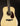 Acoustic guitar with a natural finish on a black background