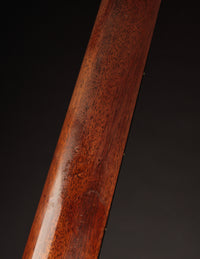Close-up of a guitar's neck with a dark background