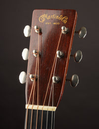 Guitar headstock with 'Martin & Co.' branding on a dark background