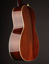 Close-up of a wooden guitar body on a dark background