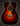 Acoustic guitar with a sunburst finish on a dark background