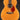 Acoustic guitar with tortoiseshell pickguard on a black background