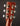Close-up of a guitar headstock with tuning pegs on a dark background