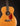 Acoustic guitar with tortoiseshell pickguard on a black background