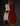 Back view of a wooden acoustic guitar on a dark background