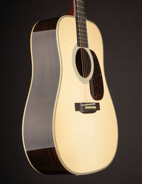 Acoustic guitar with a dark brown finish on a black background