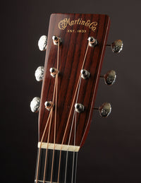 Guitar headstock with 'Martin & Co.' branding on a dark background