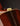 Close-up of a guitar's soundhole and brand logo on a dark background