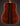 Back view of a wooden acoustic guitar on a dark background