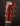 Close-up of a guitar headstock with tuning pegs on a dark background