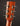 Close-up of a guitar headstock with tuning pegs on a dark background