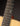 Close-up of a guitar neck with fretboard and wooden body on a dark background