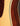 Close-up of a guitar's wooden body with a focus on the grain and finish.