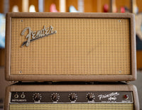 Fender reverb unit with guitars in the background