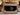 Back view of guitar amplifier with guitars in the background