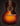 Acoustic guitar with a sunburst finish on a dark background