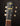 Close-up of a guitar headstock with 'Atkin' branding on a dark background