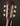 Close-up of a guitar headstock with tuning pegs on a dark background