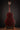 Acoustic guitar on a stand against a dark background