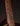 Close-up of a guitar neck with frets and strings on a dark background