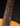 Close-up of a guitar neck with frets and strings on a dark background