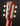 Close-up of a guitar headstock with tuning pegs on a dark background