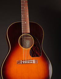 Acoustic guitar with a sunburst finish on a black background