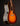 Acoustic guitar with a sunburst finish on a dark background